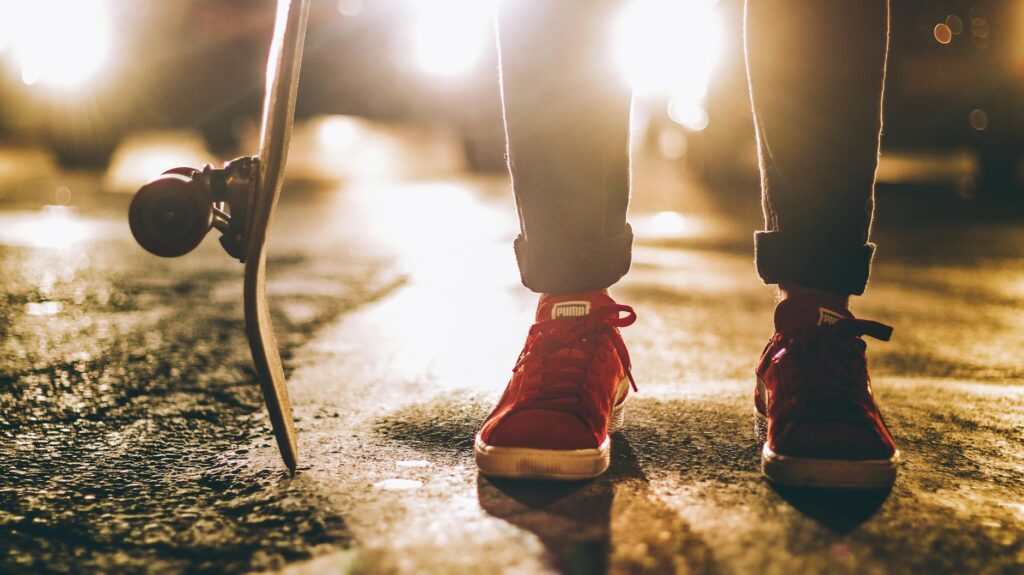 photo of person wearing red sneakers